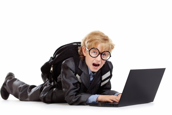 Smart schoolboy lying with his laptop gryfikacja, gry, dzieci, edukacja